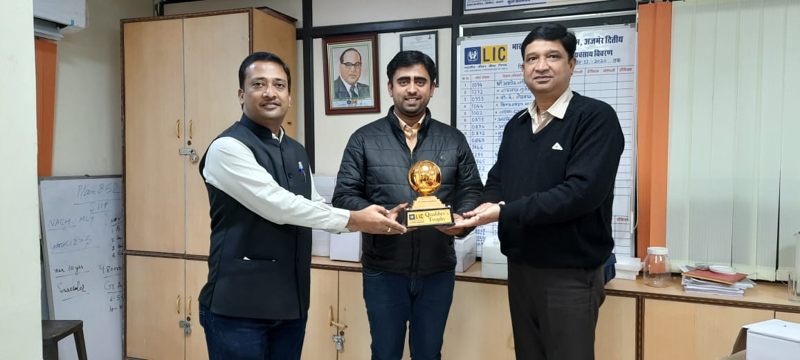 car interior from central back seat position showing driver and blurred view through windscreen of a busy road at night